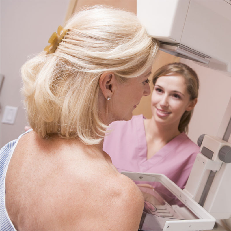 Nurse Assisting Patient Undergoing Mammogram