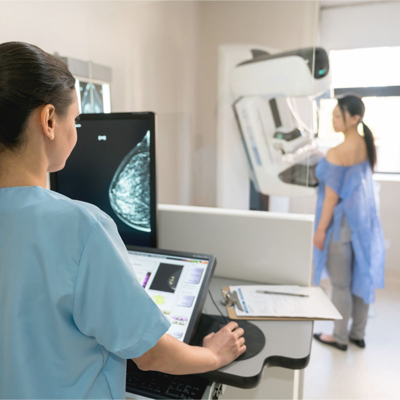 Unrecognizable nurse taking a mammogram exam to an adult patient